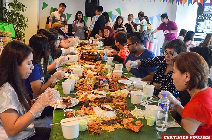 Amy Perez and our friends enjoying the boodle fight spread